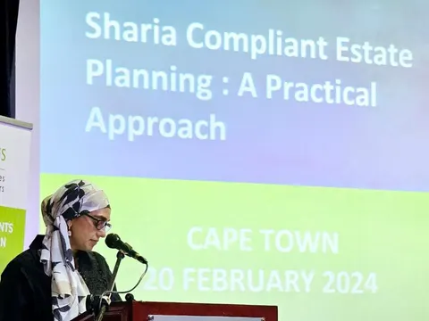 Rumana Mahomed speaking at a lectern in front of a slide titled Sharia Compliant Estate Planning: A Practical Approach, Cape Town, 20 February 2024